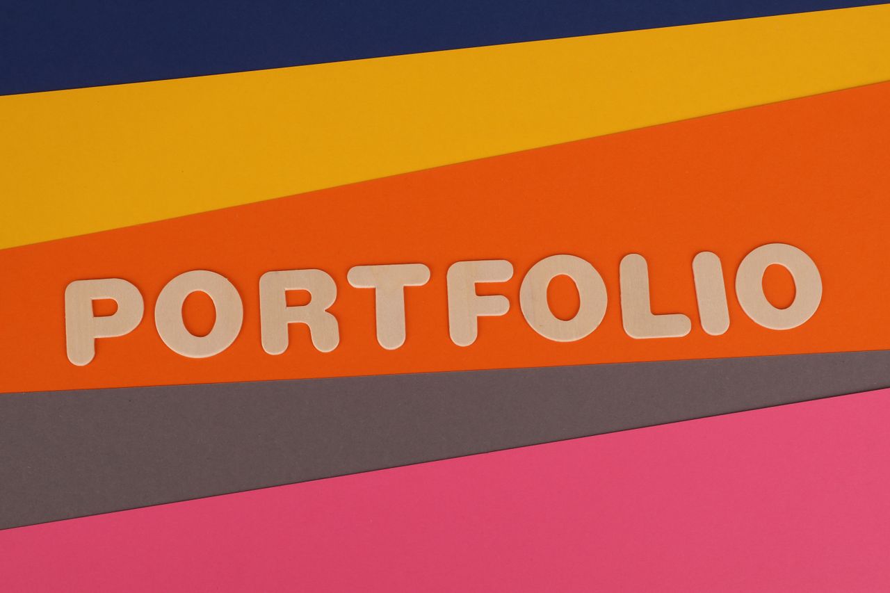 A vivid, multicolored backdrop showing the word 'PORTFOLIO' in pink lettering on colorful paper.